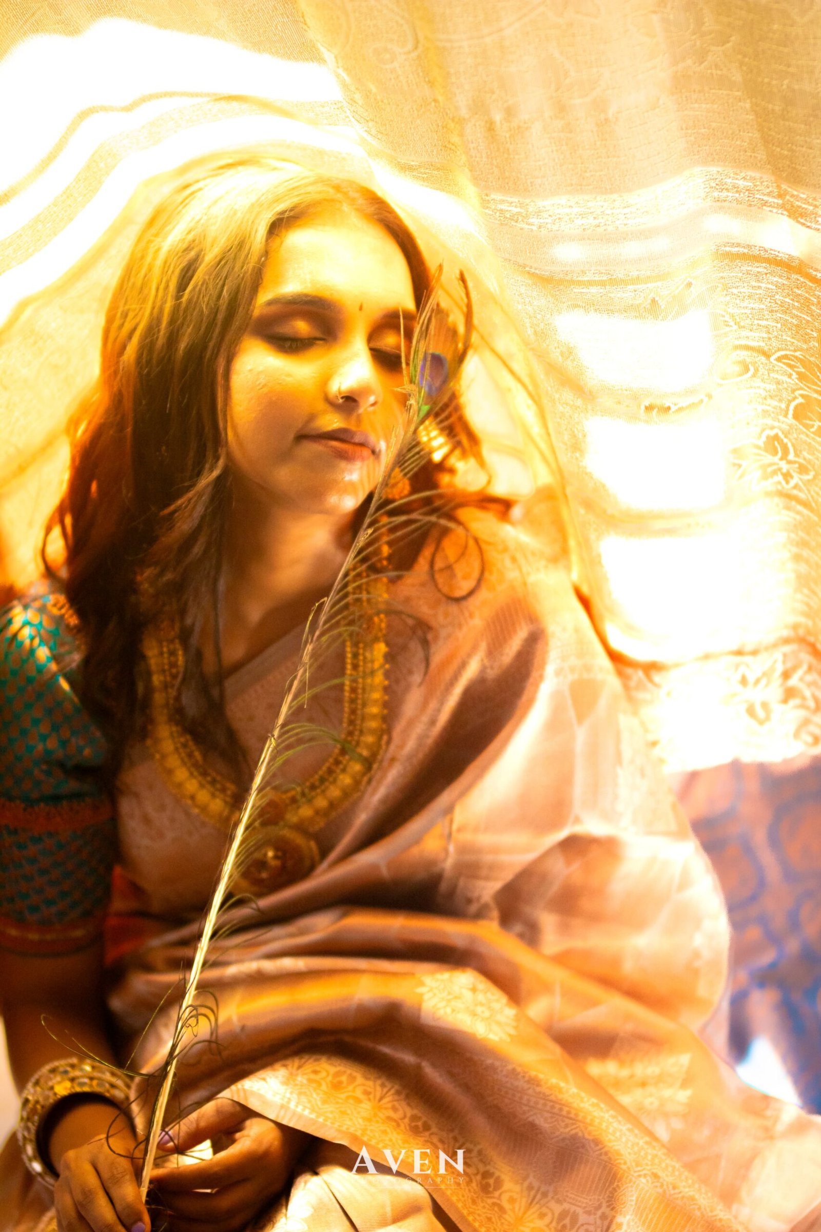 Warm light falling across a rose-toned saree and its border
