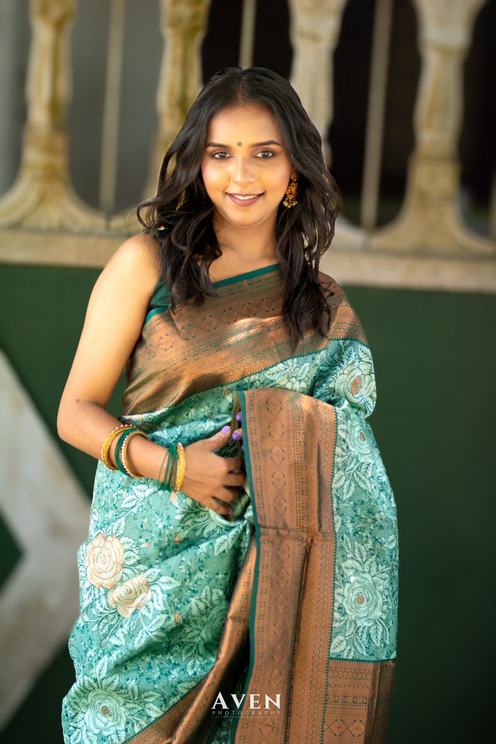 Teal and bronze saree with an expressive patterned drape